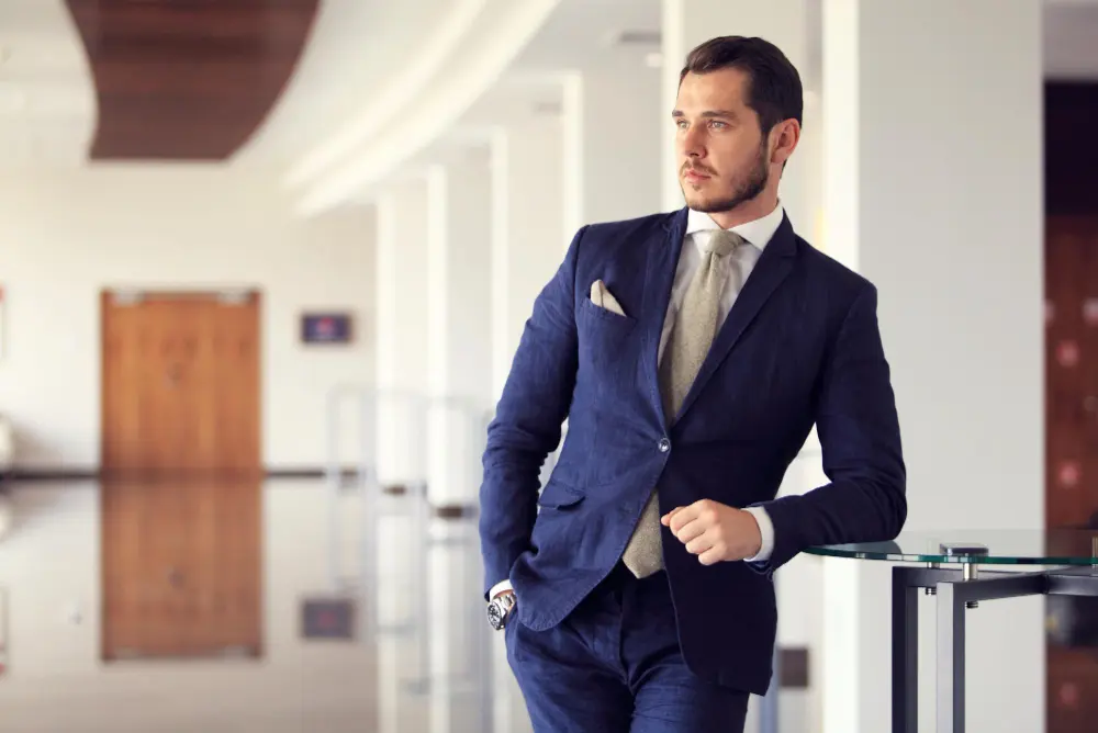 Professional wearing a tailored navy business suit in Riyadh demonstrating year-round business wardrobe style in Saudi Arabia