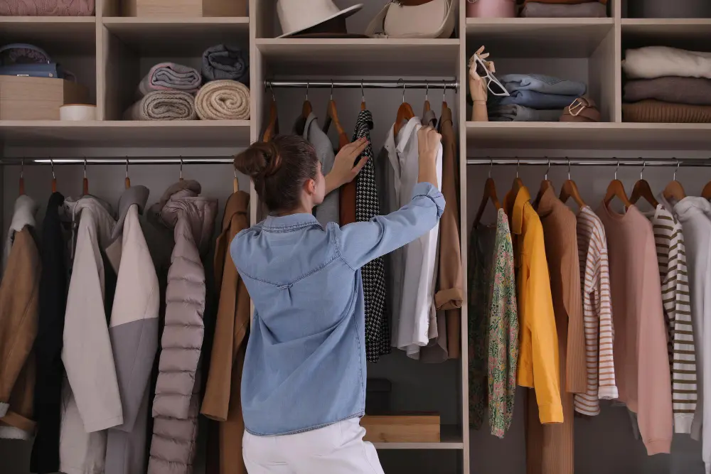 : Client showing jackets and shirts from their wardrobe to a tailor