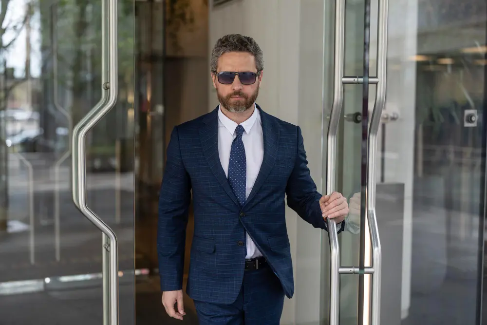 Executive wearing a lightweight tailored jacket in a modern office environment.