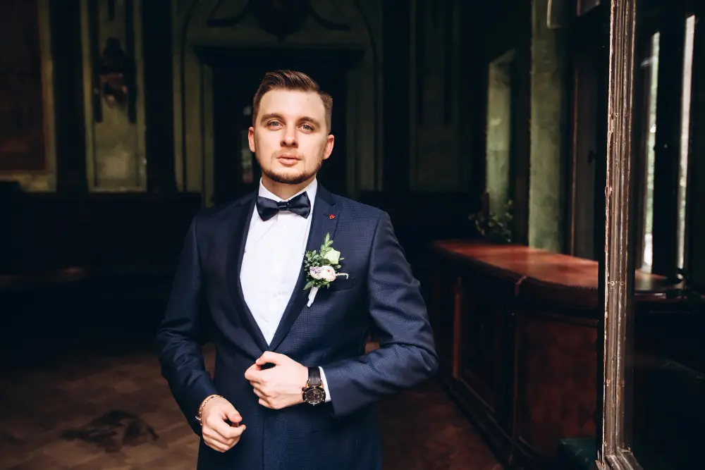 Groom wearing a bespoke midnight blue or black tuxedo
