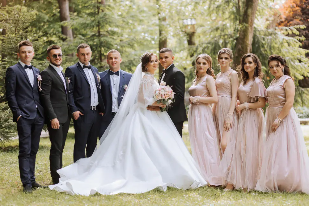 Wedding tailoring Abu Dhabi featuring groom, groomsmen and family members wearing coordinated bespoke suits.