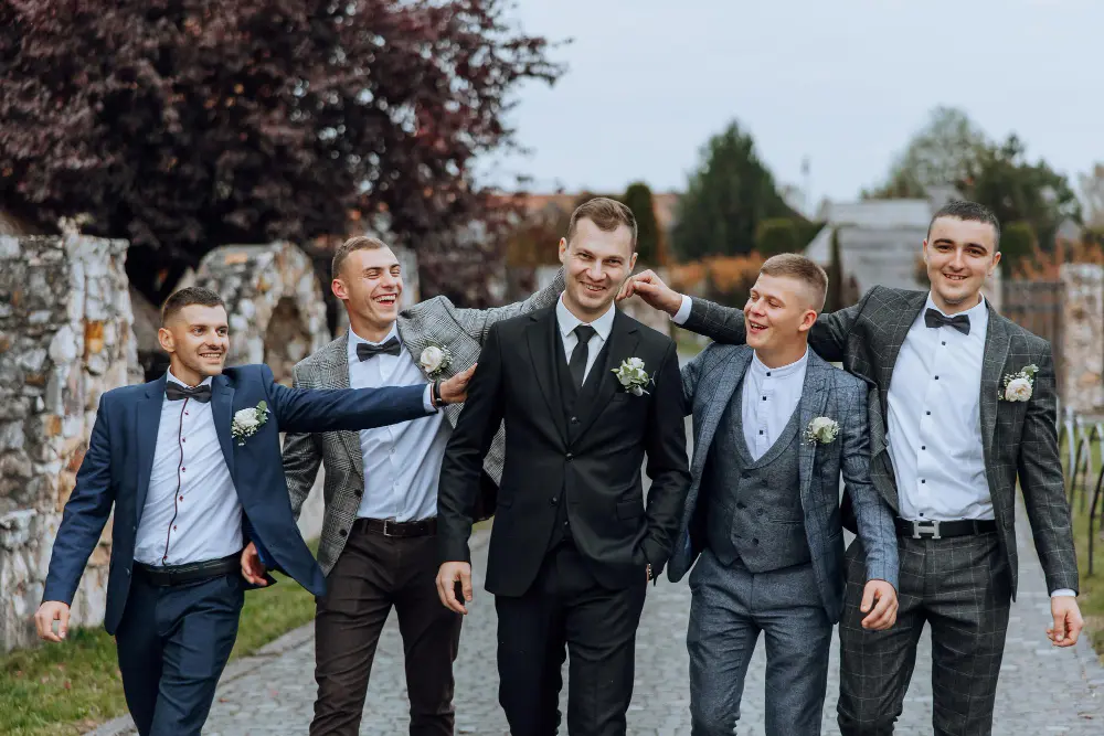 Wedding tailoring Abu Dhabi with coordinated bespoke suits for groom and groomsmen